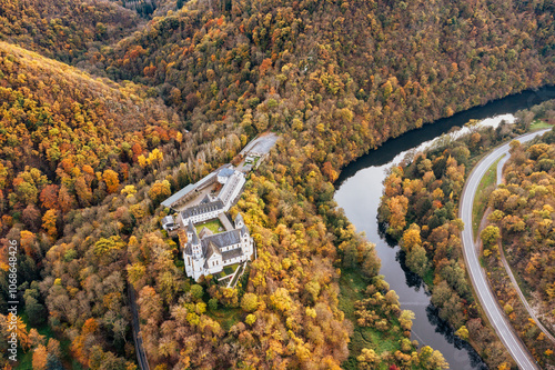 The Arnstein Monastery on the Lahn near Obernhof surrounded by autumn-colored forest from a bird's eye view