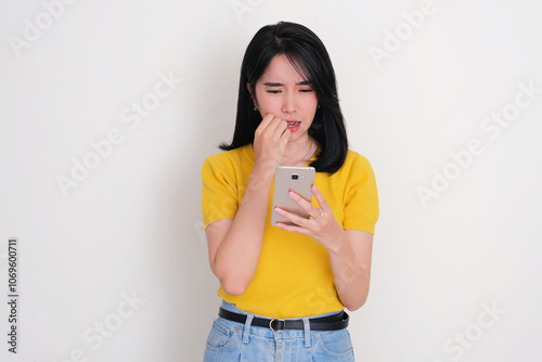 A women staring at her phone with shocked expression