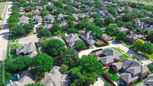 Cul-de-sac keyhole dead-end street in upscale suburban residential neighborhood cluster of new development two story houses, inground swimming pools, well-trimmed landscape in Carrollton, Texas