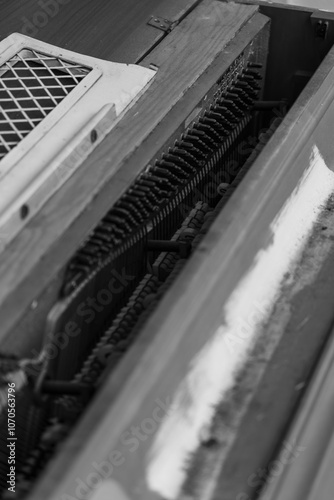 Ybor City Florida USA the monochrome photograph showcases the intricate inner workings of a piano, revealing strings and hammers. The composition highlights the mechanical complexity and craftsmanship