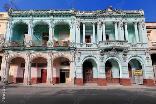 Eclectic style buildings -tenement house and former school- on 204-206 Paseo del Prado west side, light green facade, warning signage. Havana-Cuba-671