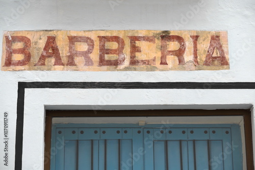 Signboard on 70 Calle Amargura Street corner with Calle San Ignacio Street, former barberia -barbershop- now a pet shop, Habana Vieja. Havana-Cuba-705