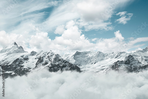 Digital composition of Mönch und Jungfrau mountains covered by white clouds