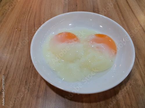 Half Boiled Chicken Egg served on a round white plate