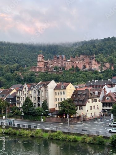 A majestic view of Heidelberg Castle, perched on a hilltop overlooking the Neckar River and the charming town below.