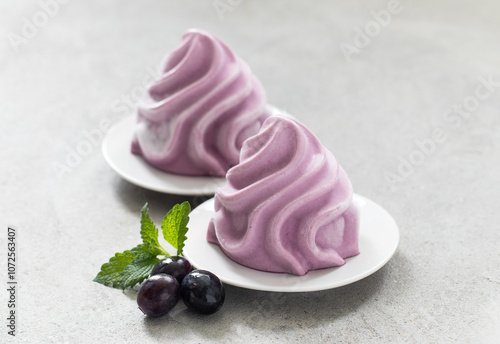 Dark blue gelato in the form of French Chantilly cream. On a plate. Close up