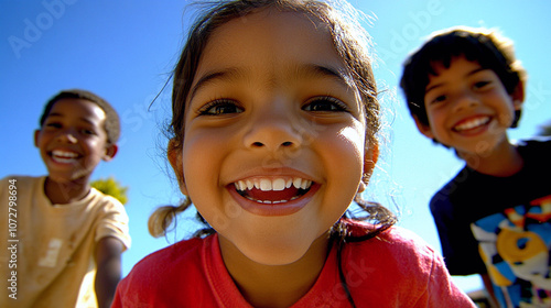 Three happy diverse children enjoying outdoor activities under blue sky