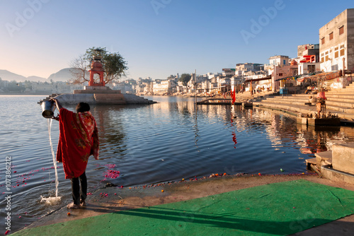 Hindu devote pilgrim bath in sacred Puskhar Sagar lake on ghats of Pushkar, Rajasthan. Pushkar is holy city for Hinduists and famous for many Hindu temples