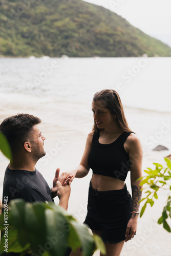 Man proposing to woman on the beach 