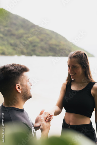 Man proposing to woman on the beach 