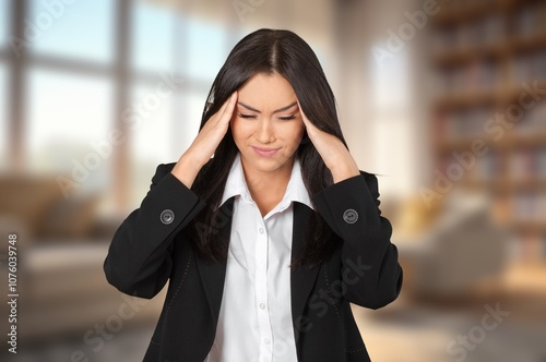 Stressed woman suffering from headache at home