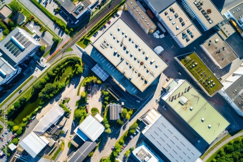 From above, a vibrant industrial zone reveals a symphony of rooftops and organized layout, highlighting the synergy of technology and manufacturing in a thriving European environment.