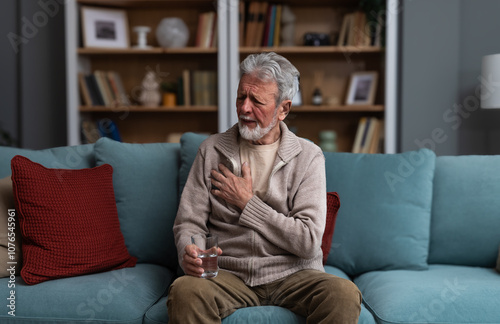 Senior man, widower or divorced, feeling sad, worry, abandoned and depressed, sitting alone at home, crying. Loneliness and sadness of older male with white hair and beard.