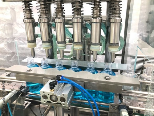 A liquid filling machine equipped with six nozzles for efficient bottle filling. The automated system is designed for precise liquid dispensing, enhancing productivity and consistency in pharma plant