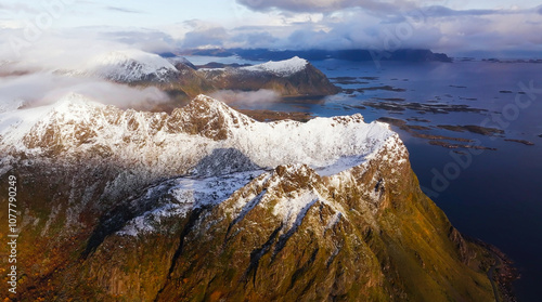 An Aerial View Captured from a Drone Shows Stunning SnowCapped Mountains with Serene Waters Below