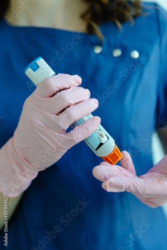 Doctor is demonstrating auto-injector syringe as an emergency treatment for allergic reaction