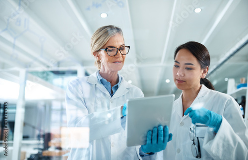 Women, scientist and discussion in laboratory with tablet, reading and review with results at pharma company. People, mentor and feedback with solution, board and medical research for mpox vaccine