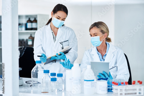 Women, scientist and discussion in lab with notes, tablet and review for experiment results at pharma company. People, mentor and feedback with face mask, ppe and medical research for mpox vaccine