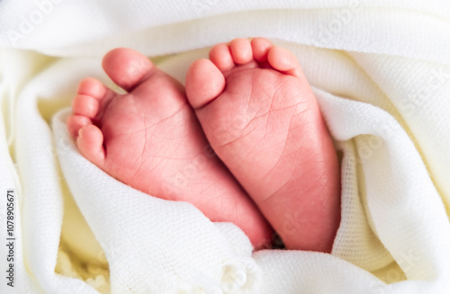 the feet of a newborn baby wrapped in heart-shaped cloth