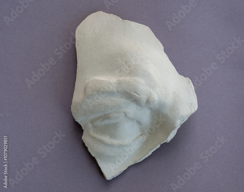 Fragment of a gypsum cast of an antique statue. Part of the human face. An eye with an eyebrow made of plaster