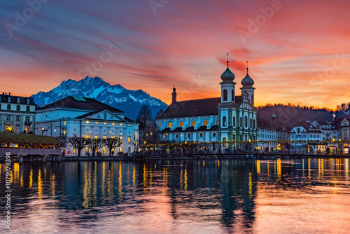 Splended sunset over the Jesuit church with Pilatus mountain at background in the evening and Rathaussteg in Christmas illumination, Switzerland