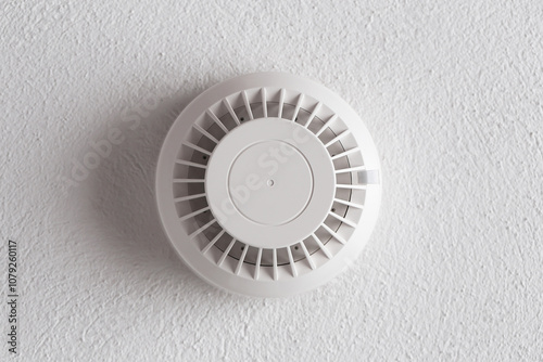 Ceiling mounted fire alarm signal and emergency detection devices in an apartment. Battery powered detectors installed for safety. Essential equipment for fire alert and danger control.