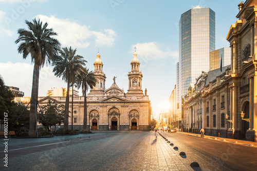 Santiago Metropolitan Cathedral and Plaza de Armas in Santiago, Chile, are beautifully illuminated by the reflecting rising sun. The cathedral, built from 1748 to 1906 in a neoclassical style.