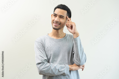 Portrait of positive confident thoughtful, happy asian young man, male standing pose looking away in casual. Smart guy thinking creative, thinks about future, isolated on gray background, copy space.