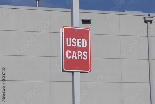 USED CARS sign at a dealership. With pricing issues, used and preowned cars are in high demand.