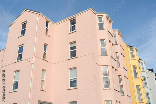 Colorful and vibrant generic multistorey apartment buildings against a bright blue sky