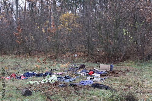 Trash in the forests of Ukraine. Bad irresponsible people pollute nature. Plastic bags, old clothes, trash are scattered across the lawn. Animals are suffering