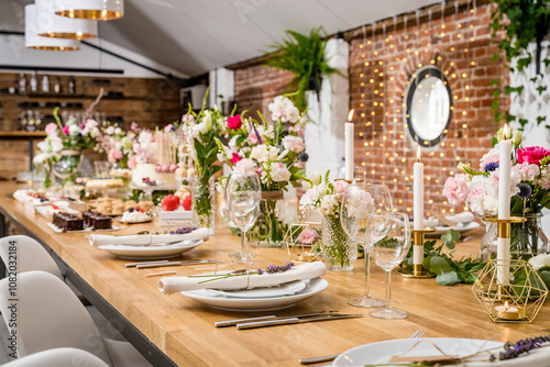 An exquisite dessert table adorned with a selection of artisanal pastries and cakes. The setup includes donuts, mousse cakes, mini cheesecakes, and layered desserts, all elegantly presented on rustic 