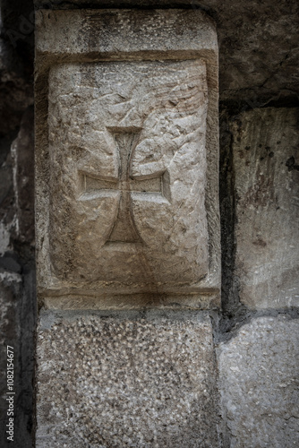 Templar cross, Romanesque carving, on Church of San Cipriano de Bolmir, Romanesque temple from the 12th century, Bolmir village, Campoo de Enmedio, Cantabria, Spain