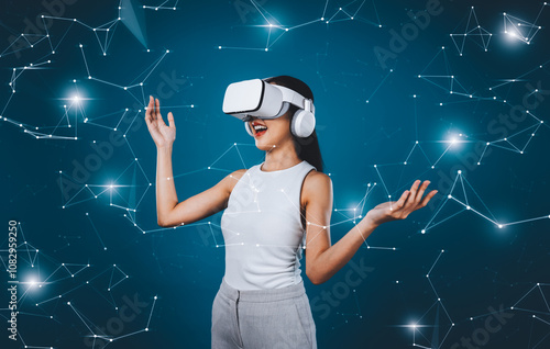 Female standing wear white VR headset and white suit connect metaverse, future technology create cyberspace community. She looking around and gesticulate enjoy communicate other users. Hallucination.