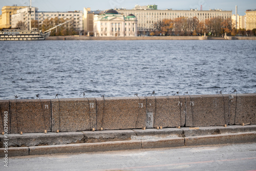 River embankment maintenance, replace and reinforce bank, aligning granite slabs. Structural improvement, infrastructure repair, urban renewal, embankment care, development of city public places