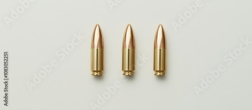 Three full metal jacket bullets arranged on a clean white background ideal for graphic design or promotional materials