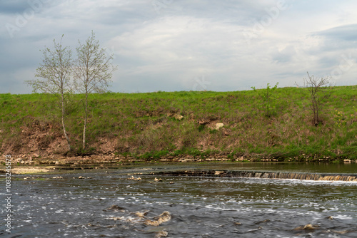 View of the Tosna River near the Tosnensky waterfall on a spring day, Sablino Railway station, village of Ulyanovka, Tosnensky district, Leningrad region, Russia