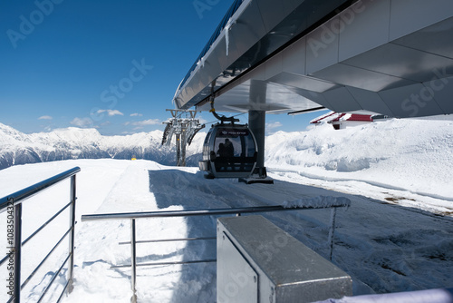 Cable cars traveling through snowy mountains in a beautiful landscape on a clear winter day - Rosa Khutor, Russia April 15, 2023