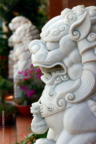 Guardian. Chinese lion statue represent Yang force, male, positive, bring, carry a ball. An Giang Province. Mekong Delta, Vietnam.