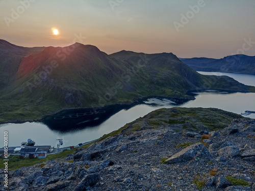 The view of the sunset over Kamoyvaer village, Rishfjorden, and Rishamntind Mountain on Mageroya Island, Finnmark, Norway