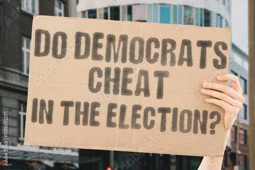 The phrase 'Do Democrats cheat in the election?' on a banner in a person's hand. Human holds a cardboard with an inscription. Integrity. Justice. Voting. Politics. Democracy. Government. Reform