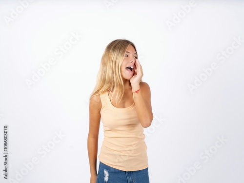 Beautiful teen girl wearing sleeveless t-shirt hear incredible private news impressed scream share