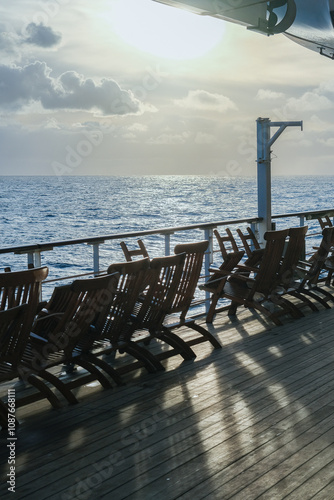 Breathtaking sunset sunrise ocean view from outdoor teak pool promenade deck of ocean liner at sea during transatlantic crossing to New York