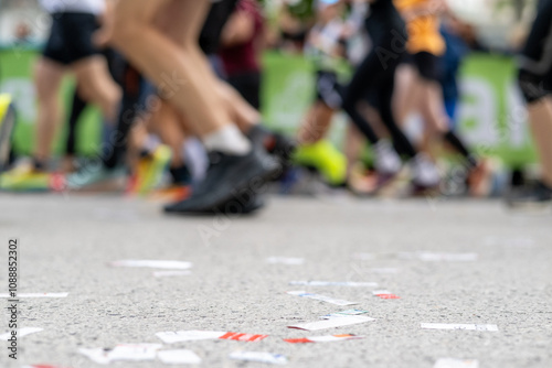 Closeup long exposure many persons and legs running marathon race stock photo with space for text non recognizable people on it