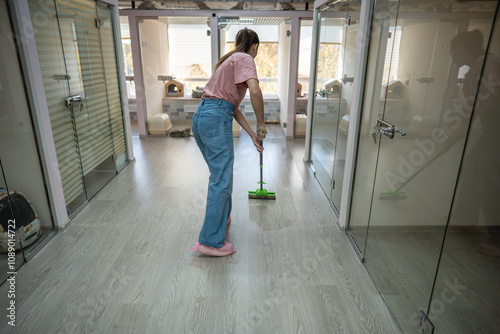 Personnel utilize mops to clean floors, ensuring clean and safe environment for cats. Hygiene, antibacterial dusting in animal accommodation area, consistent floor wash in pet hotel for best service