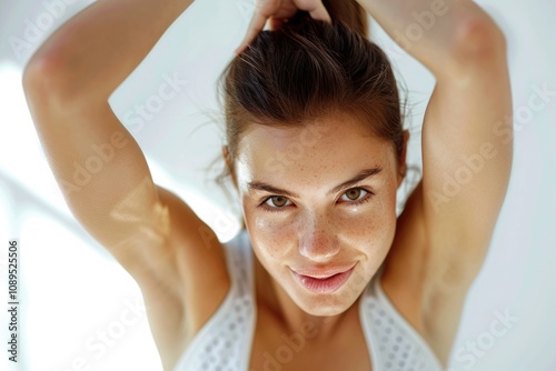 A close-up of a young woman with an updo hairstyle, likely at a beauty or fashion event