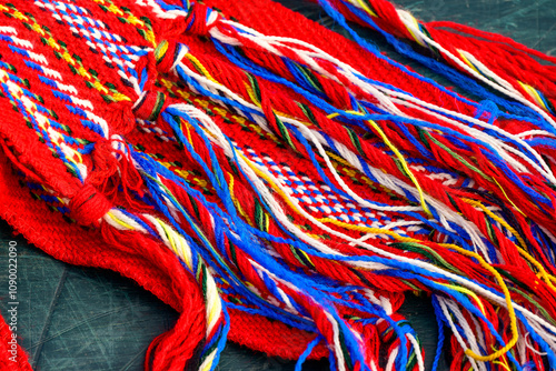 ceinture fléchée (traditional pattern) replica of the woven sash worn by voyageurs during the fur trade close up of tassels suitable as background