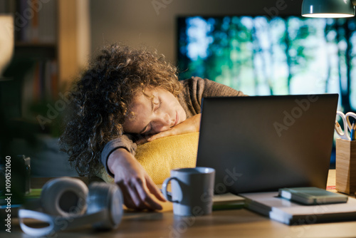 Woman falling asleep in front of the laptop