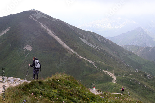 a hike in the mountains on a footpath winding through the mountain ridges