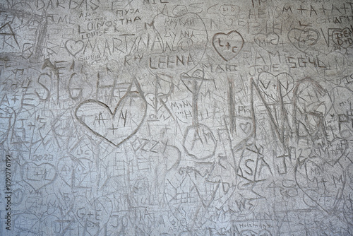 hooligan inscriptions and drawings on an old wall in Rome, Italy